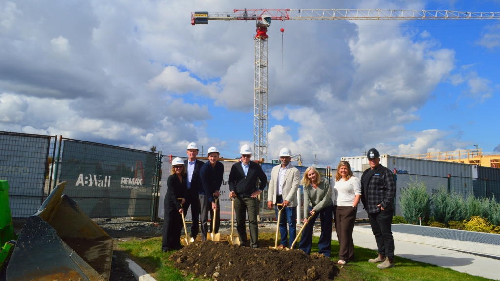Shovels in the ground at the Building 6 groundbreaking, Highstreet Village, with the tower crane overhead