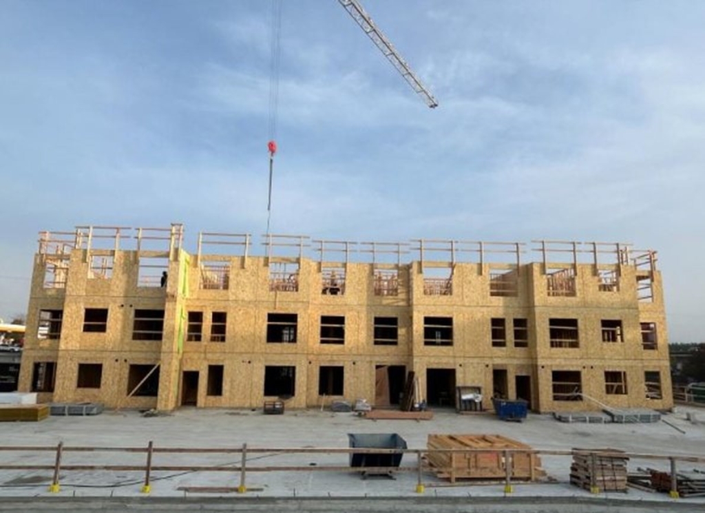 Wood framing climbing at Buildings 3 and 4, October 2026